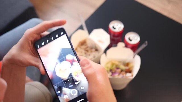 A Man takes Photo of Food with Mobile Smart Phone - Kebab Boxes with Coca-Cola