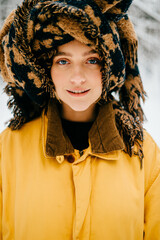 Portrait of funny young hipster girl with a turban of the scarf posing