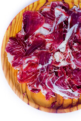 Portions of ham on wooden tray on white background
