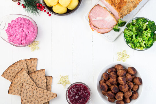 Traditional Swedish And Scandinavian Christmas Table With Baked Ham In Mustard Crumble Crust, Beet Salad, Whole Grane Crackers, Meatballs With Lingonberry Jam, Horizontal Frame, Top View, Copy Space