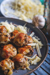Baked mushroom stuffed with fried mushrooms, onion, cheese, and spices.