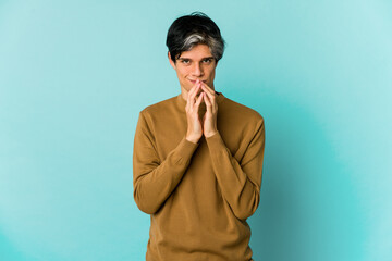 Young caucasian skinny man expressing emotions isolated on blue background