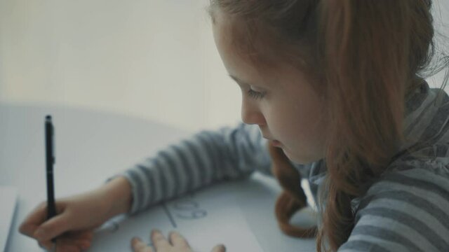 Little girl doing her homework at home