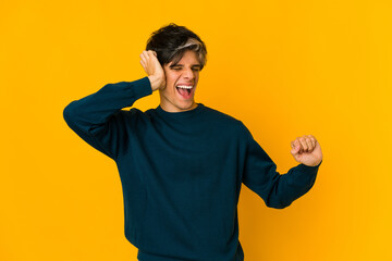 Young skinny hispanic man dancing and having fun.