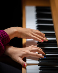 Fototapeta premium Hands of a girl playing the piano