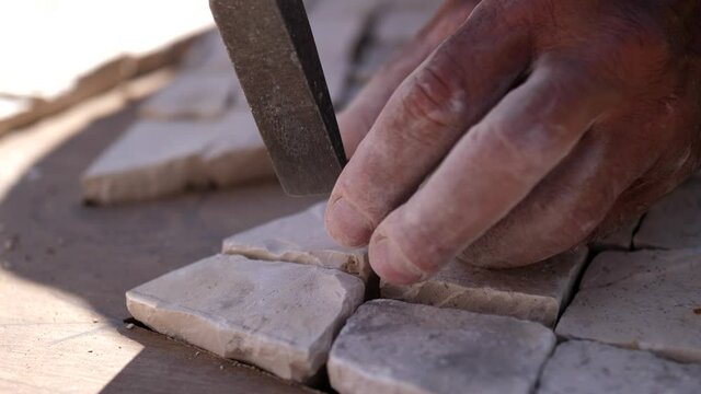paver working on traditional portuguese cobblestone pavement 4k
