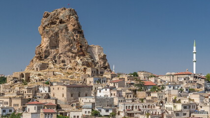 Obraz premium View of Ortahisar town old houses in rock formations from Ortahisar Castle aerial timelapse.
