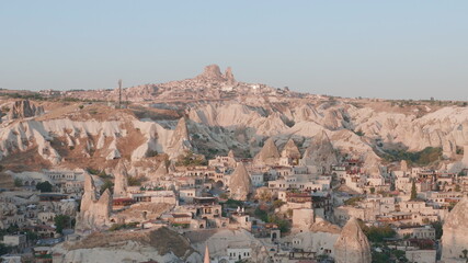 Aerial view from hot air balloon during Sunrise over the fairytale landscape hills of Kapadokya with morning light.
