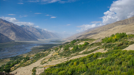 Panoramic view on Panj river valley in Wakhan Corridor and Hindu Kush mountain range in Afghanistan near Yamchun, Gorno-Badakshan, Tajikistan Pamir