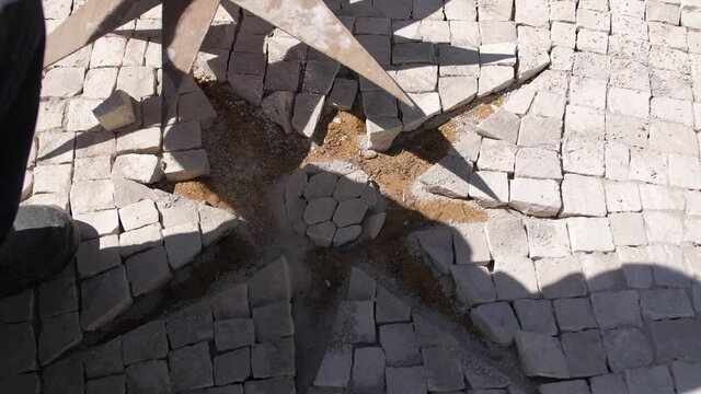 paver working on traditional portuguese cobblestone pavement 4k