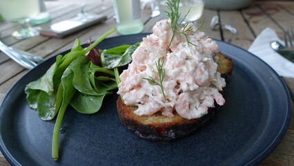 prawn cocktail served with a slice of toasted and buttered homemade bread and a little salad