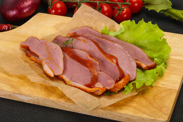 Sliced smoked duck breast served salad