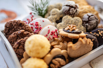 Close up of christmas cakes and cookies with santa hat 