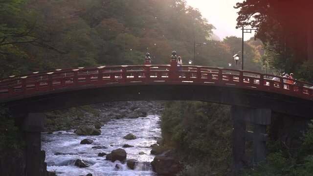 Magical scenery at famous shinkyo bridge in Nikko with people walking on it