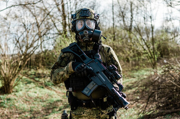 Croatian soldier wearing cropat uniform, protective gas mask M95 and carrying assault rifle G36
