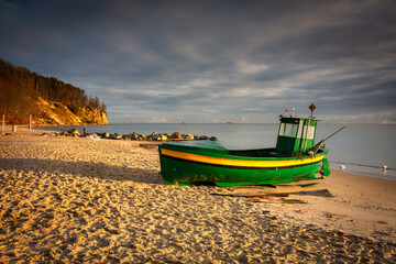 Fishing boat on the beach in Orlowo before sunrise, Gdynia. Poland