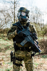 Croatian soldier wearing cropat uniform, protective gas mask M95 and carrying assault rifle G36