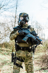 Croatian soldier wearing cropat uniform, protective gas mask M95 and carrying assault rifle G36