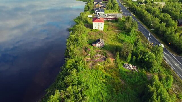 Road trip on Long highway parallel to Tornio river glossy water, Finnish Swedish border, tracking shot