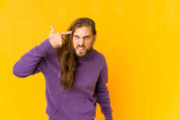 Young man with long hair look showing a disappointment gesture with forefinger.