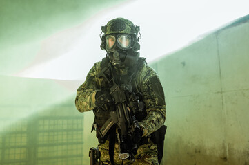 Croatian soldier in Cropat woodland uniform wearing gas mask M95 and assault rifle G36.