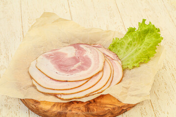 Sliced Pancetta sausage over board