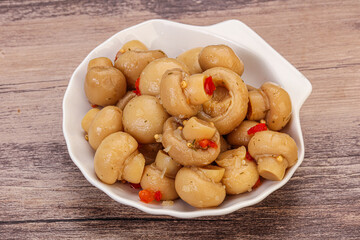 Pickled champignons in the bowl