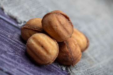 Delicious homemade cookies on the background of rough homespun fabric. Close-up, selective focus.