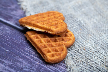 Delicious homemade cookies on the background of rough homespun fabric. Close-up, selective focus.