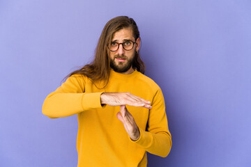 Young man with long hair look showing a timeout gesture.