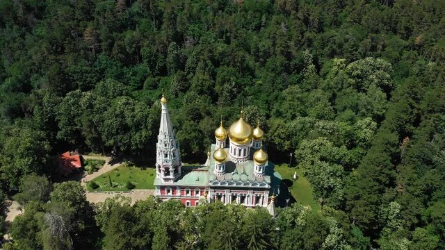 Memorial Temple Of The Birth Of Christ, Shipka Memorial Church By Green Forest In Bulgaria. - aerial orbit shot