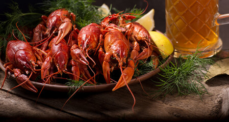 Crayfish boiled on a dish with dill spices and lemon.