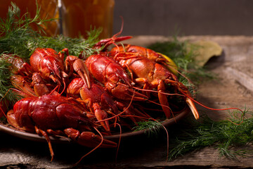Crayfish boiled on a dish with dill spices and lemon.