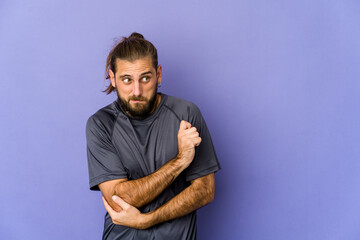 Fototapeta premium Young man with long hair look has friendly expression, pressing palm to chest. Love concept.