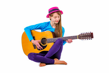 A girl kid plays guitar on a white studio background