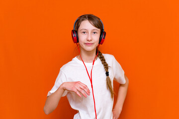 Attractive 12s girl listens to music on headphones closeup
