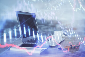 Forex Chart hologram on table with computer background. Multi exposure. Concept of financial markets.