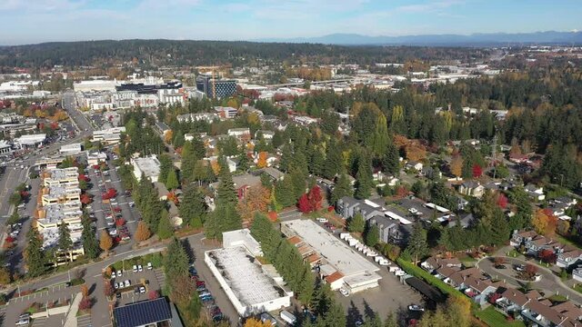 Aerial / drone footage of the new Spring District in Bellevue, Washington downtown with residential and commercial highrise buildings along Interstate highway 405 in King County