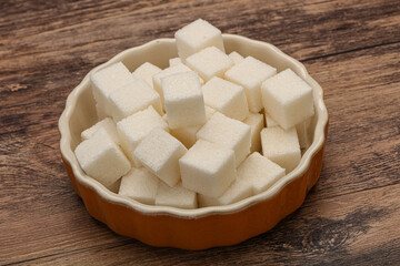 Refined white sugar cubs in the bowl
