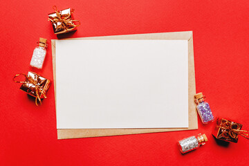 Blank christmas note with gift and toy on red isolated background. New Year concept