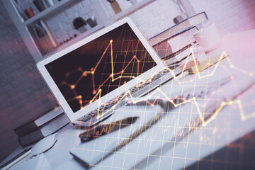 Financial chart drawing and table with computer on background. Double exposure. Concept of...