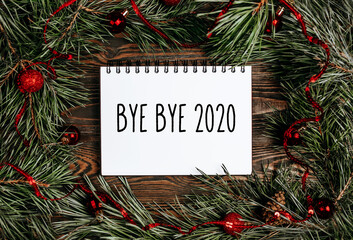 Merry christmas and merry new year concept with gift boxes, toys and notebook with text Bye bye 2020 Hello 2021