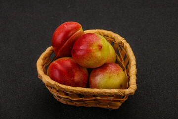 Sweet small nectarines in the basket