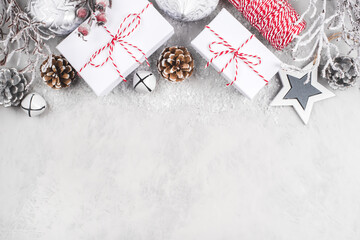 Festive Christmas background with white gift boxes and Christmas decorations.