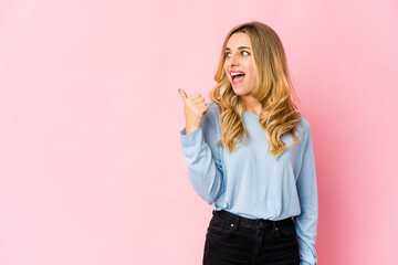 Young caucasian blonde woman raising both thumbs up, smiling and confident.