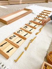 Fototapeta na wymiar Montessori material Segen wood board # 1 with golden material