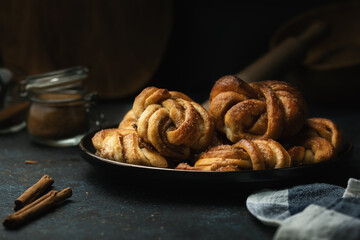 Traditional Swedish cinnamon buns served on a plate. Very popular snack throughout Scandinavia.
