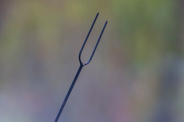 Iron fork for roasting sausages on open fire.