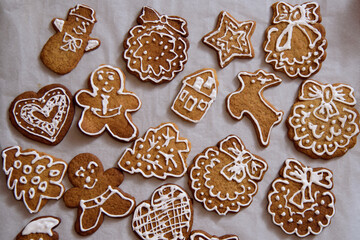 Decorating freshly baked cookies with icing. Christmas and New Year celebration traditions, festive sweets, family culinary. Traditional gingerbread. 