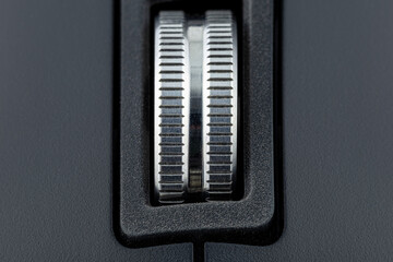 A macro shot of a metal roller from a modern wireless computer mouse.
